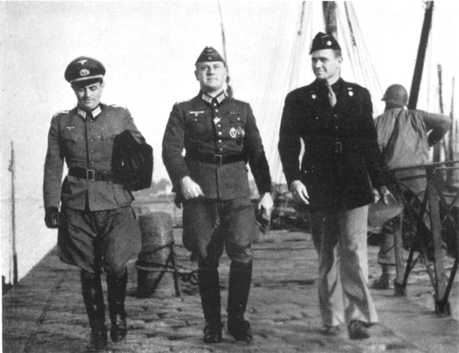 Andrew Gerow Hodges (right) is negotiating with Oberleutenant Dr. Alfrons Schmitt (left) and Oberst Otto Borst (center) for the release of the American POWs. The picture was taken on the quay at Etel, France on Nov. 16, 1944.