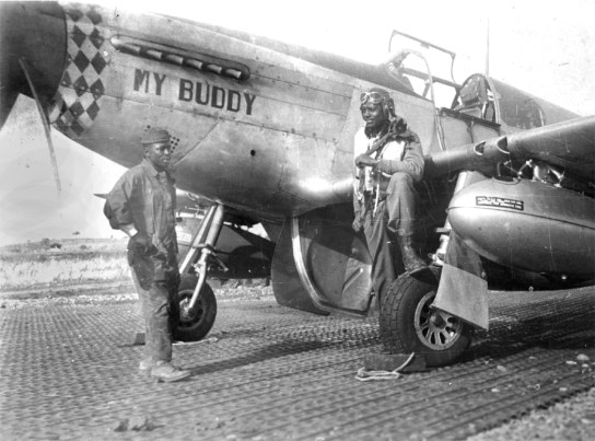 Lt. Charles Bailey in his flying gear with his boot on the wheel of the P-51 Mustang named for his father. He shot down a German fighter flying this plane while serving in the all-black 99th Fighter Squadron in Europe during World War II.