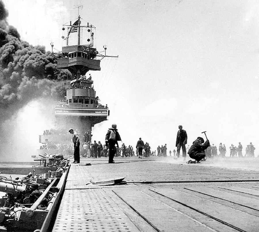 The carrier USS Yorktown is on fire after a Japanese bomb went down her smoke stack during the Battle of Midway on June 4, 1942. The picture was taken by PhoM2/C Bill Roy, a Navy photographer aboard the ship who lives in Naples, Fla.