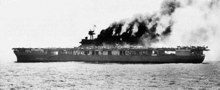 The USS Yorktown burns on June 4, 1942, after a Japanese bomber dropped a bomb down the smoke stack of the battered carrier.