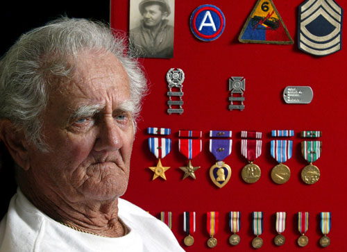Mike Sovan was the commander of a Chaffee tank in Patton’s 3rd Army during World War II. A picture of him while in the service along with his 6th Armored Division patch, Sergeant stripes and his military medals are all part of a shadowbox displayed on the wall of his Englewood, Fla. home. Sun Photo by Jonathan Fredin.