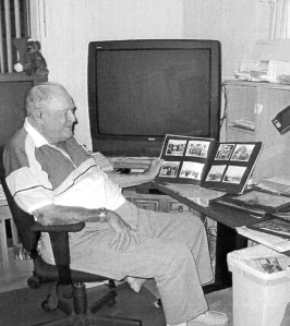 Dyer looks at a scrapbook of World War II pictures of himself and his buddies at his home in Buttonwood Village mobile home park in Punta Gorda, Fla.