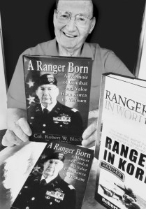 Col. Robert Black of Port Charlotte, Fla., holds a copy of his latest book A Ranger Born. The Airborne Ranger saw action in two wars, Korea and Vietnam. He wrote his memoir about his experiences in the service. At the right are his other two books: Rangers in WW II and Rangers in Korea. Sun photo by Don Moore