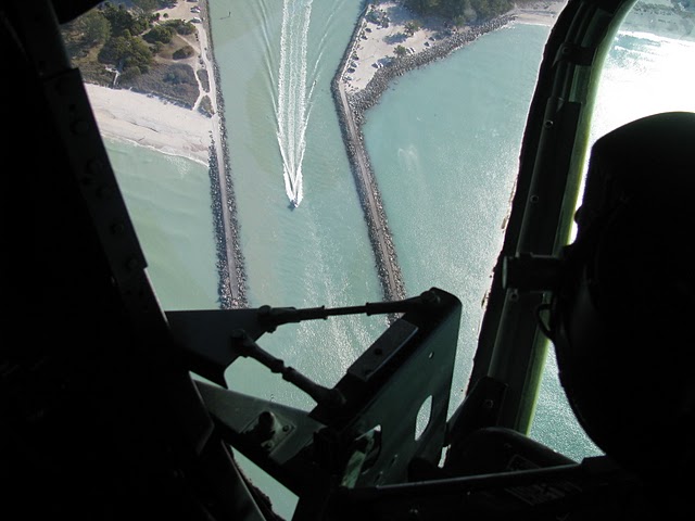 A boat races through the slot into the open Gulf at the Venice Jetty. The picture was taken over the once top secret Norden bomb sight in the nose of “Witchcraft,” the B-24 bomber that flew into Venice Municipal Airport last week. Sun photo by Don Moore