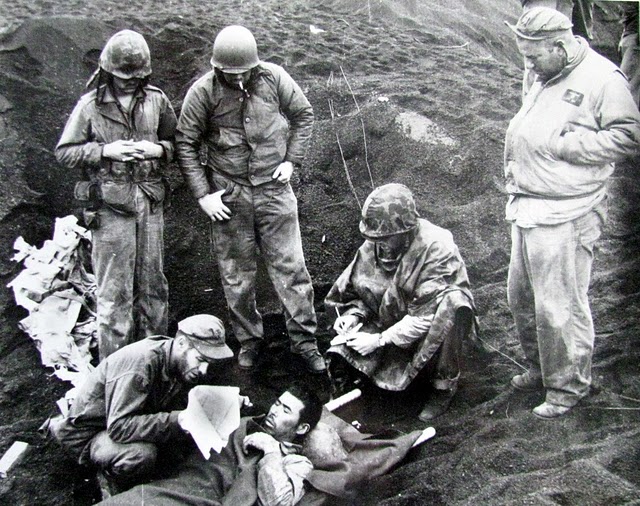 Marines tend to a Japanese soldier wounded on Iwo Jima. He is one of the very few who survived the 36-day battle. Photo provided by Dick Honyak