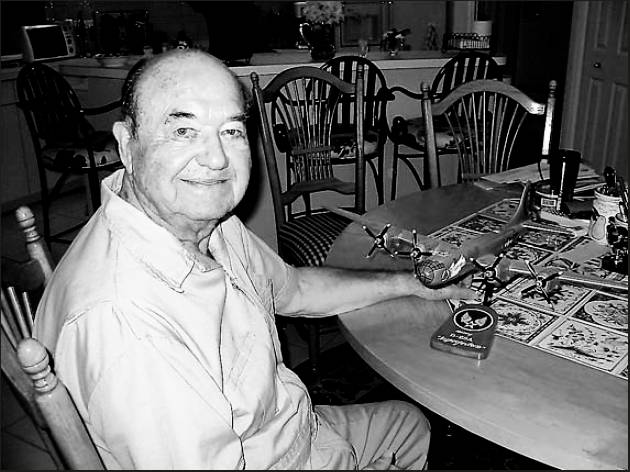 Harold Keathley of Oyster Creek in Englewood has a model of a B-29 "Superfortress" similar to the one in which he flew 35 missions during World War II. Sun photo by Don Moore