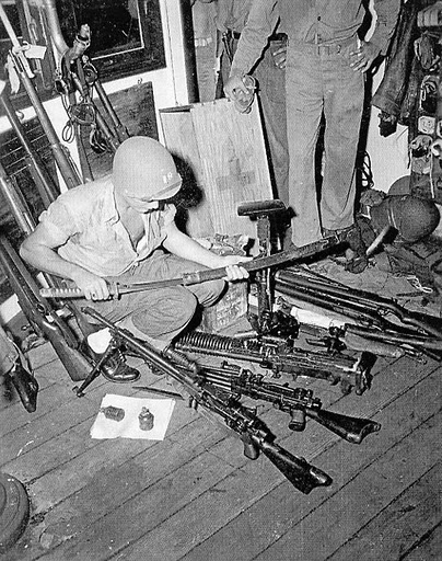 A Marine checks out some of the captured arms found aboard the Tachibana Maru. Photo provided