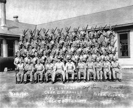 This is Russell Holland's Parris Island graduation picture taken in Nov. 1943 according to the information at the bottom of the photograph. He is the Marine holding the M-1 rifle in the top row 2nd from the right. Photo provided