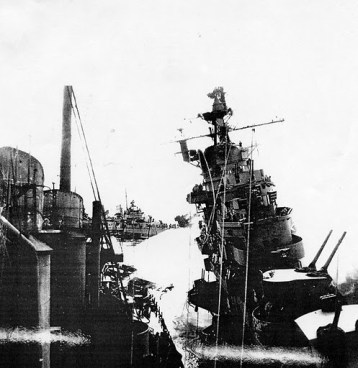 The heavy cruiser USS Santa Fe (left) pours water on the 27,000 ton carrier USS Franklin after she was hit by two bombs from a low-flying Japanese fighter plane off the coast of Japan on March 19, 1945. In the background is the USS Hickox that John Wisse served on. He and his shipmates were credited with saving a number of sailors from the Franklin that day. Photo provided
