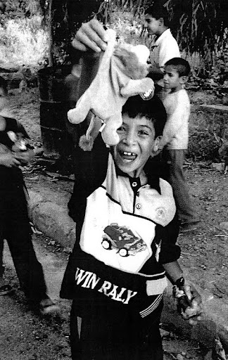 A Kurdish youngster is all smiles because of the Beanie Baby lion he just received from an American soldier. Kids in Iraq mob American service personnel hoping to get candy or toys. Army Photo by Spec. Bryanna Poulin