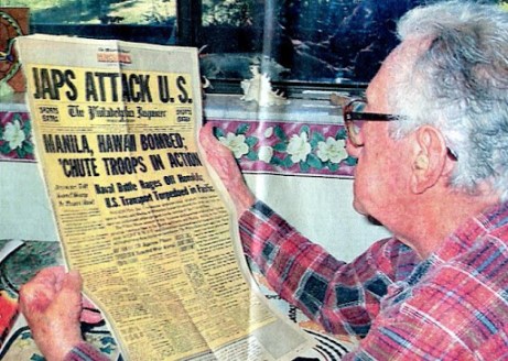Frank Garcia of North Port, Fla. looks at a reproduction of the front page of the Philadelphia Inquirer for Dec. 8, 1941. He joined the Marines about a week after the Japanese bombed Pearl Harbor. Sun photo by Don Moore
