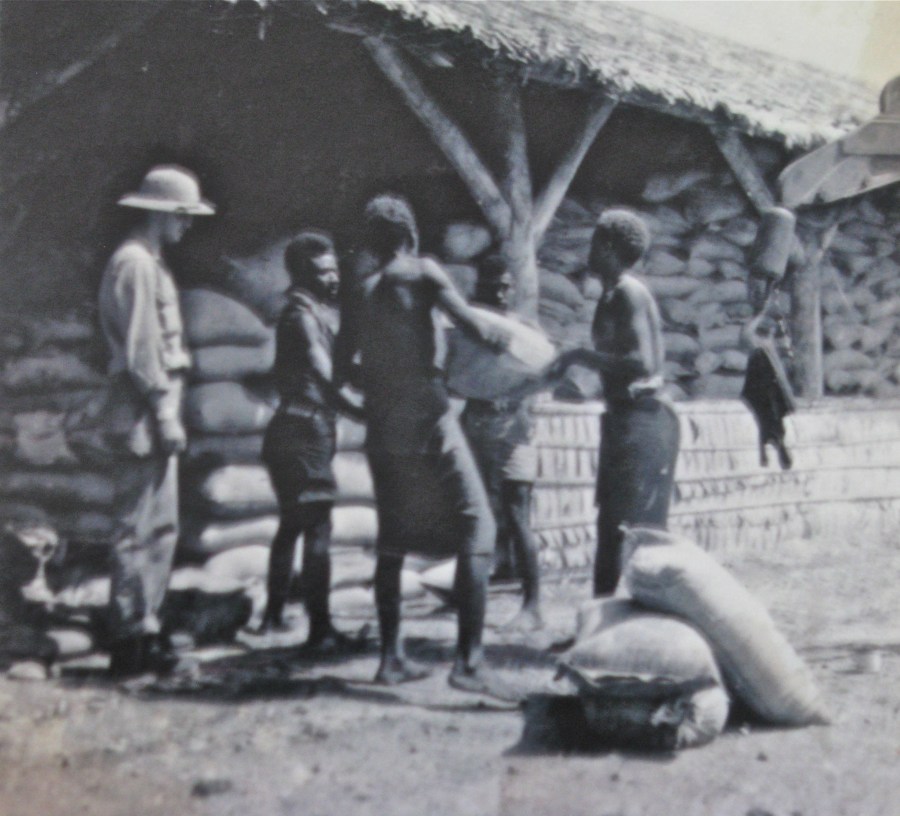 Former Cpl. Walter Mitchell of Englewood, Fla. supervises a group of natives moving sacks of grain out of a warehouse the Americans built on Guadalcanal during WW II. Photo provided by Walter Mitchell
