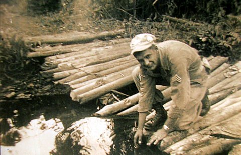 Kaplun puts the finishing touches on a foot bridge in New Guinea. Photo provided