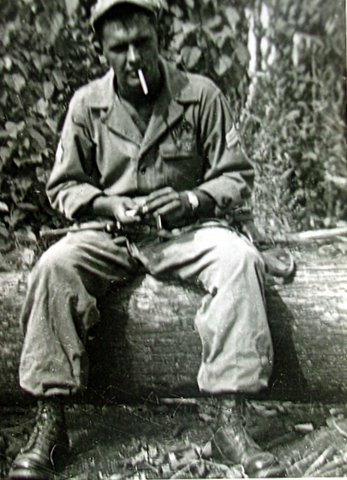 Checking his carbine during a break in the fighting in New Guinea. Photo provided