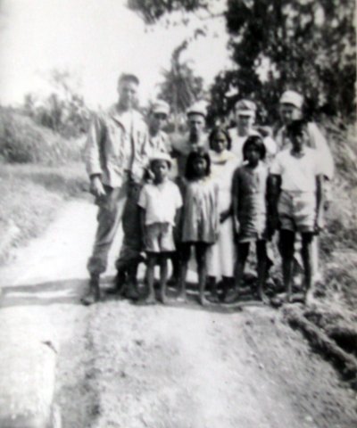 Kaplun and his buddies with several Philippine children. He's the guy in the back row second from the right with the cap. Photo provided.