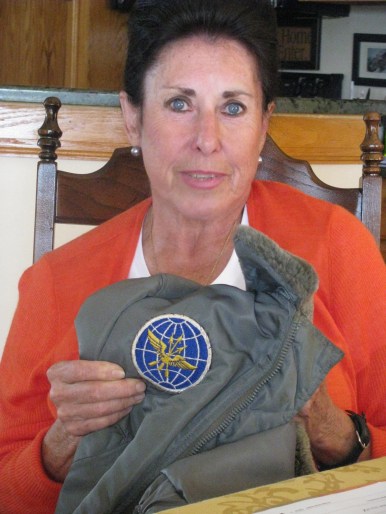 Carr holds an Air Force jacket she wore in the service. It has the shoulder patch of the Military Air Transport Command. Sun photo by Don Moore