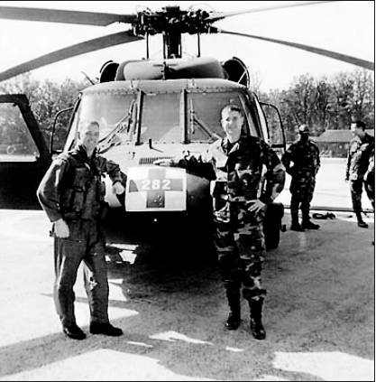 Maj. Arturo Rodriguez-Martin, right, in front of a rescue helicopter with its pilot when Rodriguez-Martin served with a U.S. Army medical unit in Bosnia in 2002. Photo provided