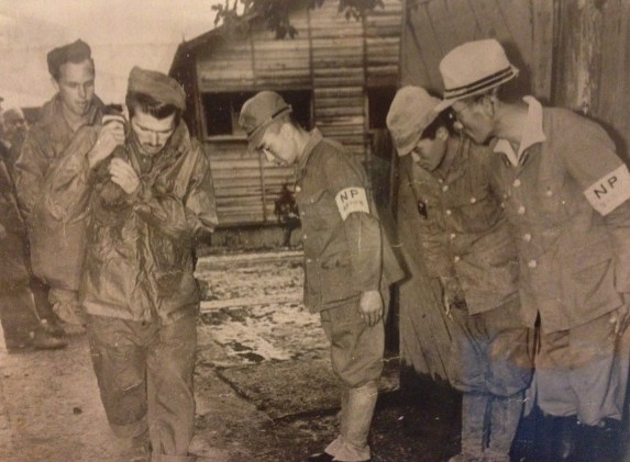 UPI--Former Japanese guards at the Ofuna prison camp, 16 miles from Yokohama, described as one of the worst in the area, bow low in the old polite manner as Luther P. Johnson (foreground), Portland, Me., and John Chapman, Los Angeles, Calif., prisoners until Japan capitulated, carry their bags from the camp to freedom. Photo provided by Nancy Poe
