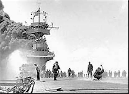 The carrier USS Yorktown takes a hit from a kamikaze plane during the Battle of Midway that began in the Pacific 64 years ago. Photo by PhoM2/C Bill Roy