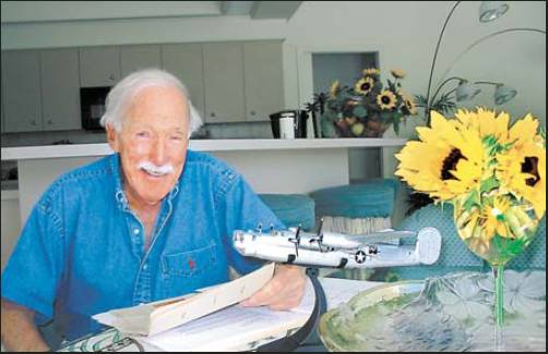 Former 1st Lt. Ed Sealy is pictured at his home in Southwest Florida with a model of a B-24 “Liberator” bomber like one he flew on 35 missions over Nazi-occupied Europe during World War II.  Sun photo by Don Moore