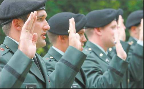 West Point graduate Bryan Coward, left, is sworn in during the Oath of Officership commissioning ceremony May 26 after commencement exercises. Sun photo by Sarah Coward
