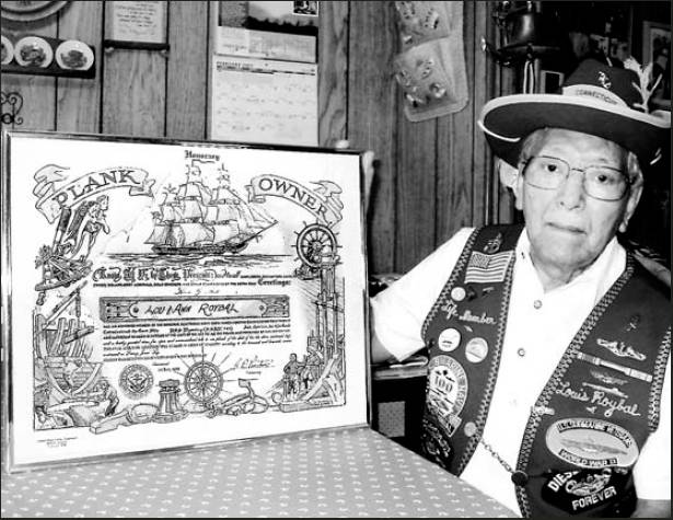 Louis Roybal of Village of Holiday Lakes in Englewood holds an honorary “Plank Owner’s” certificate given to sailors who served aboard ship when they were commissioned.