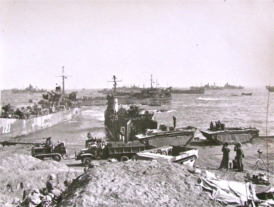 LST-121 is shown on the beach at Iwo Jima in the shadow of Mount Suribachi several days into the 36 day battle in which 6,800 American servicemen were killed and 12,000 wounded on this 8 square mile volcanic island. Almost all of the 20,000 plus defenders were annihilated by battle's end. Photo provided