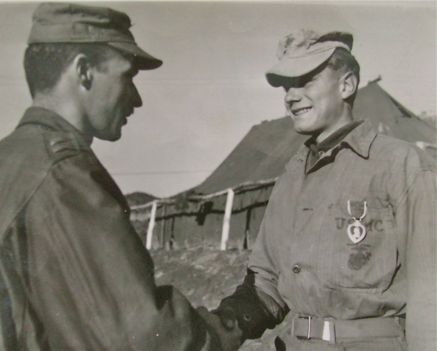 Cpl. Robert Robb receives the Purple Heart from his platoon commander, Lt. Bernie Adams, at a ceremony in Korea during the war. Photo provided