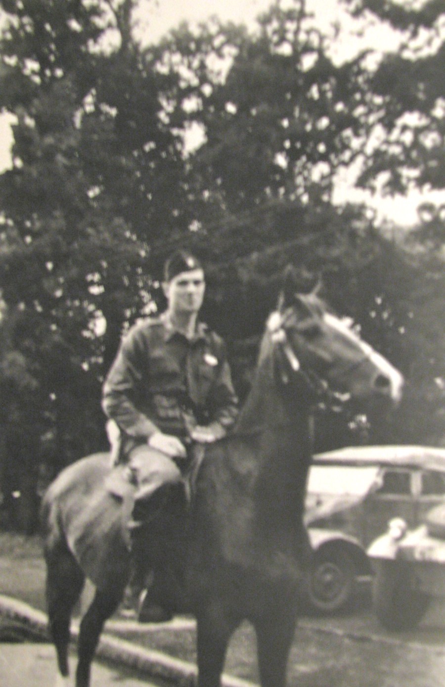 Charles Maloney tries out a horse he had corralled in a POW camp he operated in Alsfeld, Germany. The horse belonged to one of the six captured German generals in the camp. Note the Volkswagens in the background. Photo provided
