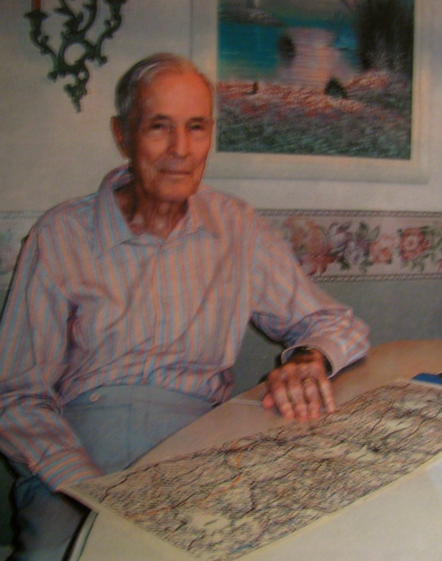 Maloney looks at a map that encompasses the area known where the Battle of the Bulge and the Hürtgen Forest where he and his squad fought fought and died in World War II. Sun photo by Don Moore