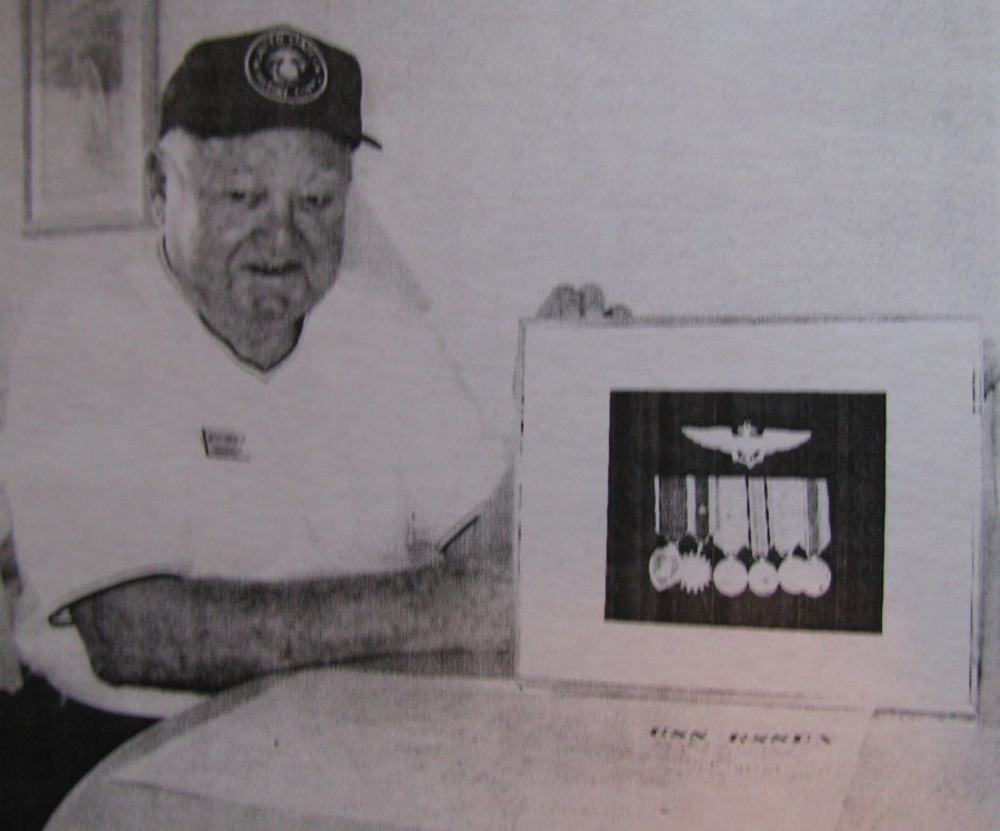 LeBoefu holds a framed picture of his medals which includes the Purple Heart, two Air Medals, a Presidential Unit Citation and three Battle Stars for taking part in the battles of Iwo Jima, Okinawa and Tokyo. Sun photo by Don Moore