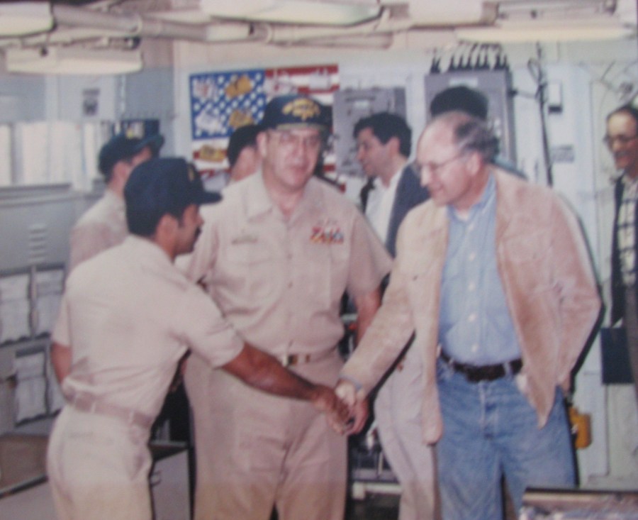 Avenancio shakes hands with Secretary of War Dick Chaney aboard the guided missile cruiser USS Bunker Hill during the start of