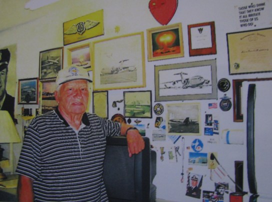 Lt. Col. John Pickering (Ret.) of Punta Gorda stands bedside a wall covered with Air Force memorabilia from World War II, Korea and the Cold War. Sun photo by Don Moore