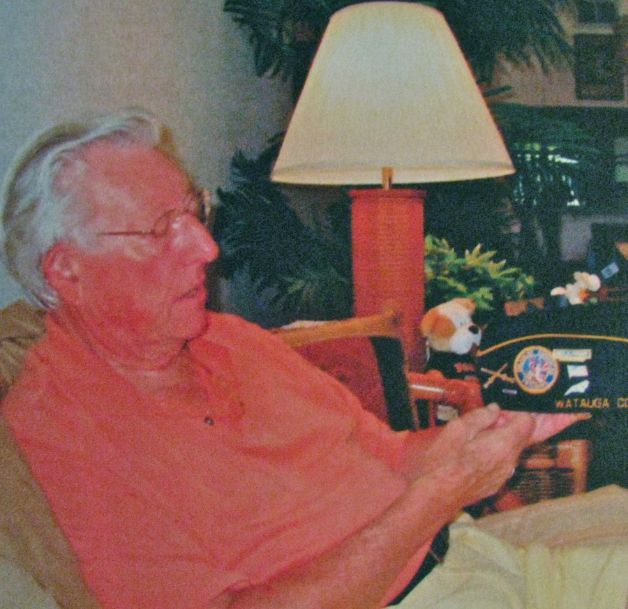 Richard Erdey of Englewood, Fla. looks at his Disabled American Veteran's cap he's worn for years at annual meetings. Sun photo by Don Moore