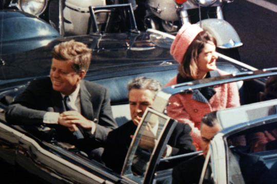 Moments before President John Kennedy was assassinated in Dallas, he and his wife, Jackie, were all smiles as they waved at the adoring crowd that mobbed the curbside during their trip to Dallas, Texas on November 22, 1963.