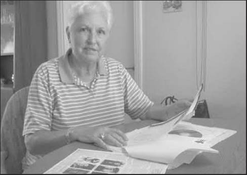 Aggie Konings looks over information about the part she played as a teenager in WWII. She and her husband, Jeff, live in Port Charlotte. Sun photo by Don Moore