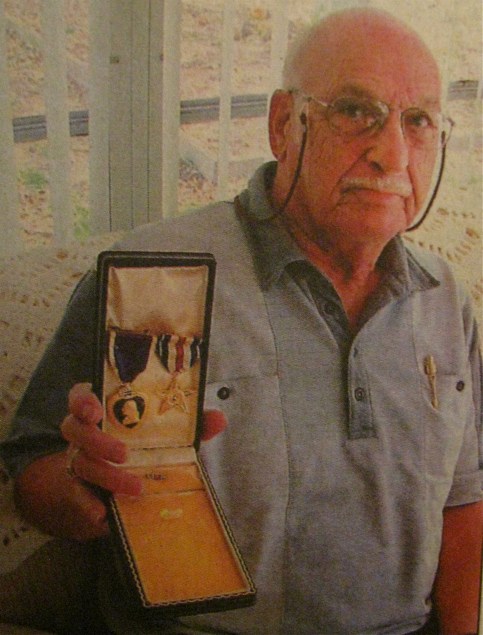 At 81, Broner holds a box containing the Purple Heart and Silver Star he received while fighting at the Battle of Buna on New Guinea during the second World War. Sun photo by Don Moore