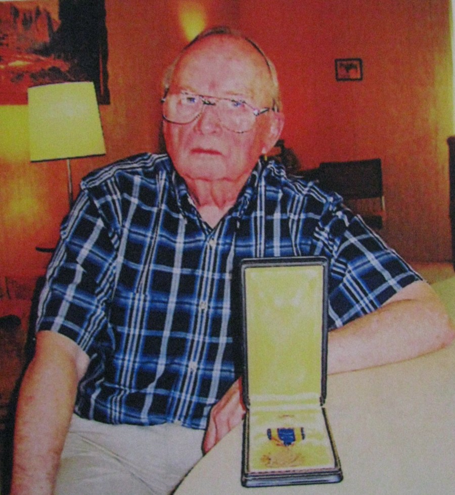 Former Sgt. Giff Stowell who flew nose a turret gunner in a B-24 "Liberator" in the Pacific in World War II is pictured with one of the two Air Medals he received during the war. Sun photo by Don Moore