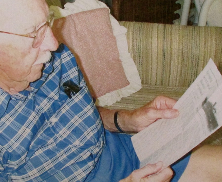 Dan Middleton of Englewood, Fla. looks at a story clipped from the Seattle Times about the sinking of the transport ship HMT Rohna on Nov. 26, 1943, during World War II. He is a survivor of one of the biggest American naval disasters of the war. Sun photo by Don Moore 