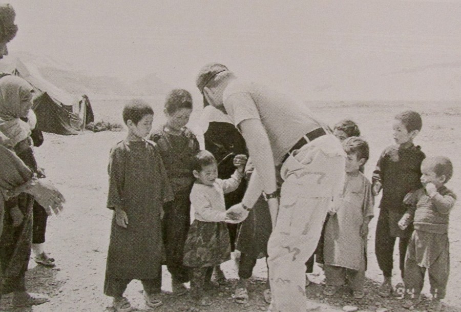 Sgt. Joe Smith shakes hands with Hazara children in central Afghanistan. Photo provided by the Smith family