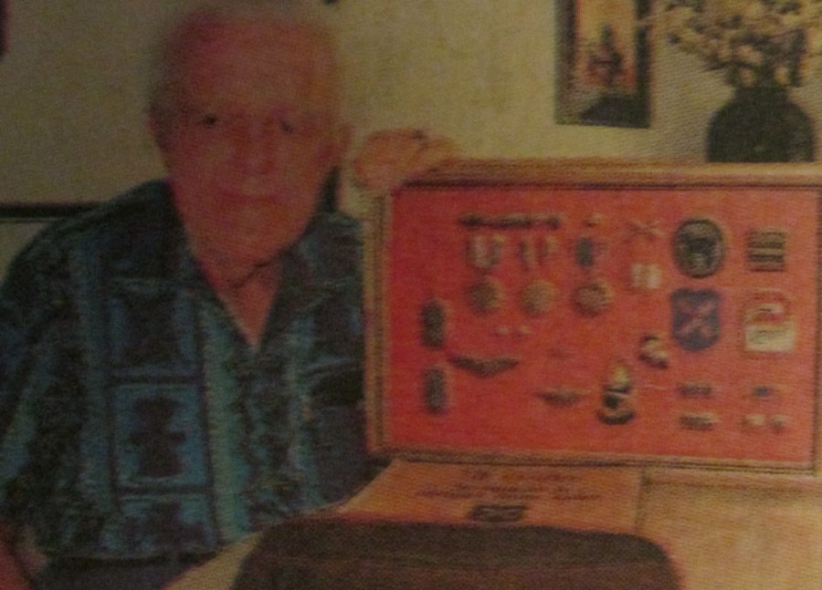Capt. John Johnson of Port Charlotte, Fla. is shown with his World War II medals, dog tags and insignias. Sun photo by Don Moore