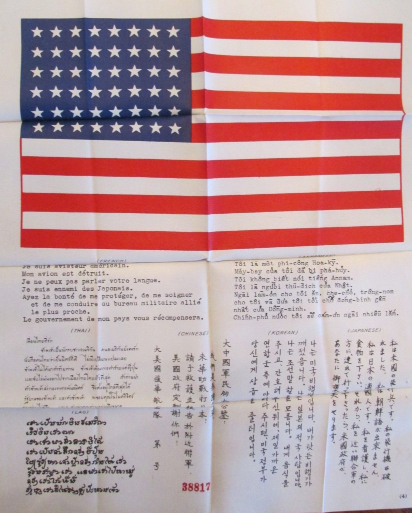 A "Blood Chit" is what they called it. U.S. aviators flew with this American flag with a message in Japanese, Chinese, Lao, Korean and Thai asking that the American with this flag and message be returned to Allied lines. The finder would be paid for his efforts, thus the term "Blood Chit." Sun photo by Don Moore