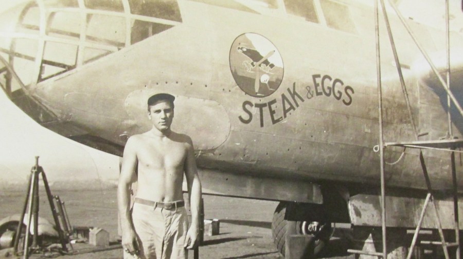 Spatharos stands in front of an A-20 twin-engine bomber named 'Steak and Eggs