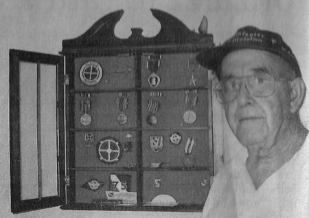 Pfc. William McWha is pictured with his medals from World War II. He received two Purple Hearts, a Bronze Star for valor, the Combat Infantryman's Badge, five Battle Stars for five European Campaigns and the Word War II Victory Medal among others. Sun photo by Don Moore