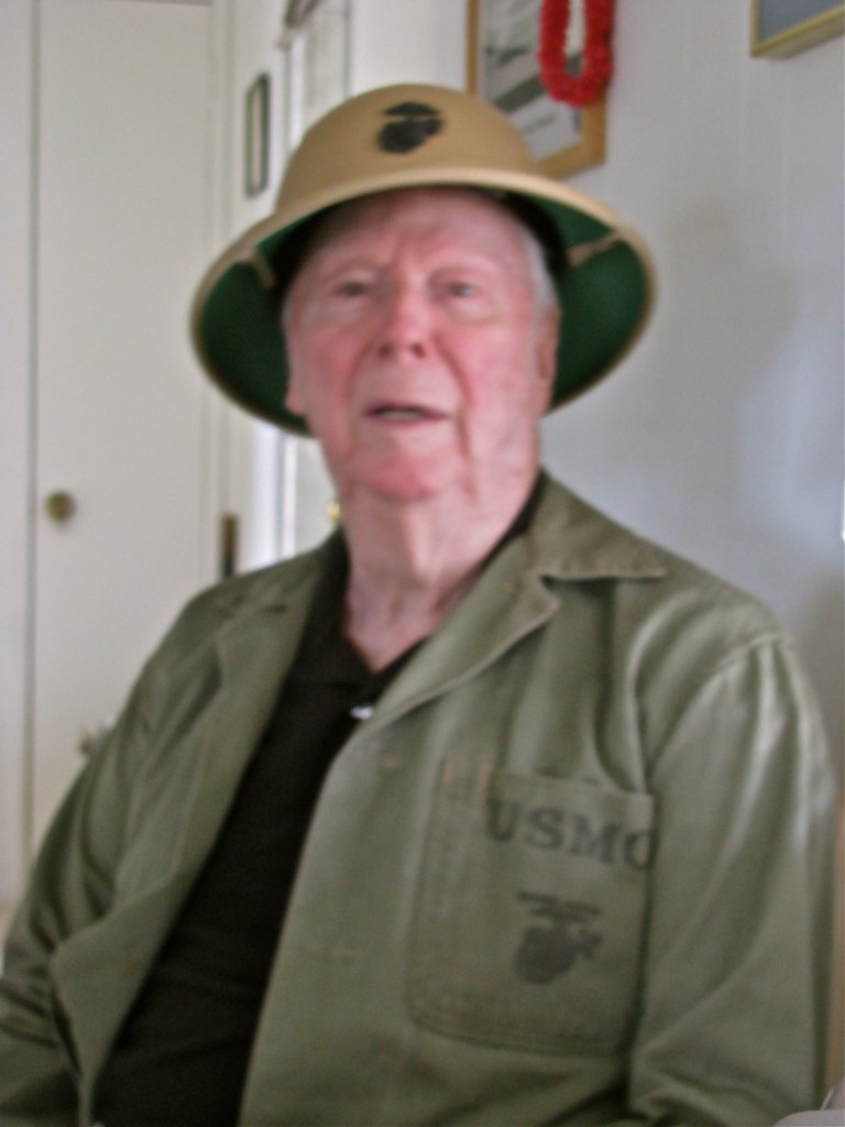 Raymond still has his Marine pith helmet with the Corps' emblem on the front. He can still fit into his green fatigue shirt after all these years even if it's a little tight. Sun photo by Don Moore