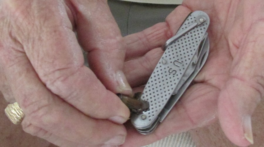 His broken pocket knife and the enemy AK-47 round that destroyed it while he was flying in a helicopter over enemy territory in Vietnam. Sun photo by Don Moore 