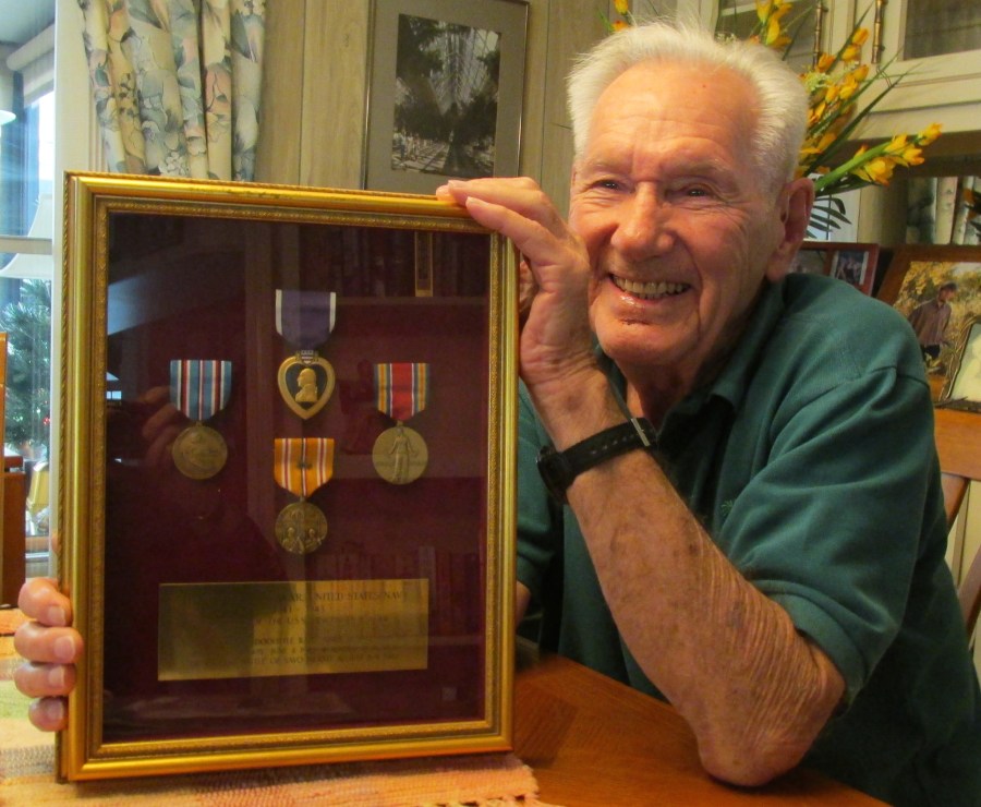 Cynkar holds a shadow box of military commendations. He received a Purple Heart, Asiatic-Pacific Theater Medal with two battle stars and the World War II Victory Medal, and the American Defense Medal. Sun photo by Don Moore