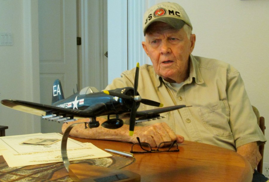 Peterson tells his story at 86 at his home in Englewood. In front of him is a model of a Corsair fighter like the ones he kept flying while serving as a Marine aviation mechanic between the Second World War and the Korean conflict. Sun photo by Don Moore