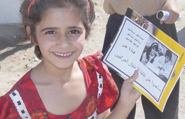 The young Iraqi girl is all smiles as she shows off her first report cad with all As. For the first time in her life she was atending a school which Ponkratz and the soldiers of the 432nd Civil Affairs Battalion buil in the Falluah area. Photo provided
