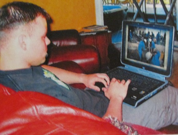 David Frey of Port Charlotte, Fla. just returned to his home base in California after a tour of duty in Iraq with the Seabees. They 2002 graduate of Port Charlotte High School takes a few minutes to check some of the pictures he took in Iraq on his laptop. Sun photo by Don Moore 